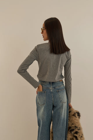 JEANS VITA ASIMMETRICA TWIST CON BOTTONI